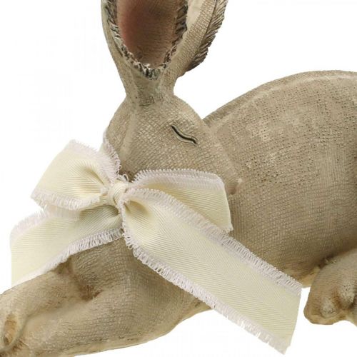 Floristik24 Velikonoční zajíček ležící s mašlí Polyresinová velikonoční dekorace 28cm