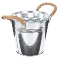 Lesklý kovový kbelík s